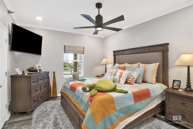 bedroom with a ceiling fan, ornamental molding, and wood finished floors