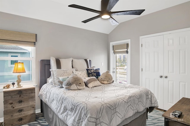 bedroom featuring lofted ceiling, a closet, ceiling fan, and access to outside