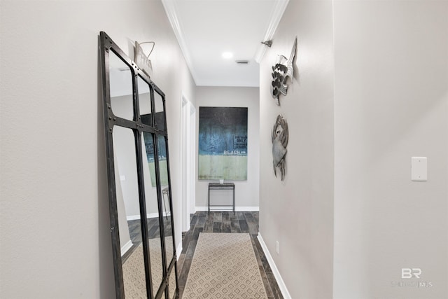 corridor with ornamental molding, dark wood-type flooring, and baseboards