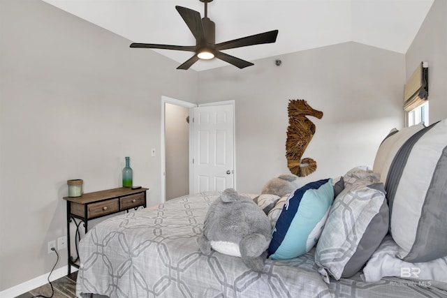 bedroom featuring lofted ceiling, ceiling fan, baseboards, and wood finished floors