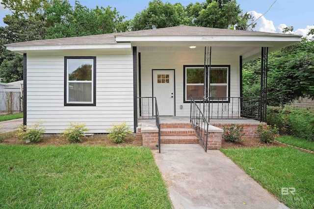 bungalow with a porch and a front yard