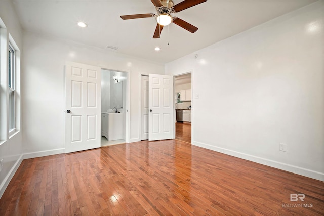 interior space featuring baseboards, visible vents, hardwood / wood-style flooring, ceiling fan, and recessed lighting