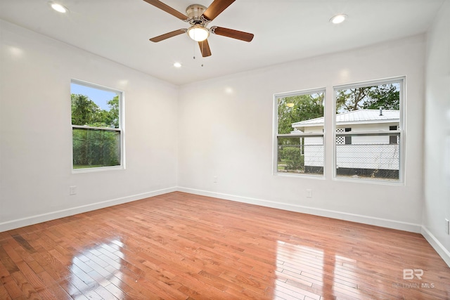 unfurnished room featuring recessed lighting, light wood-type flooring, and baseboards