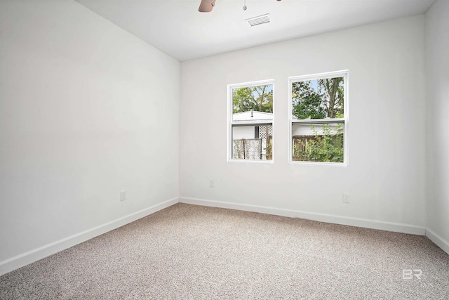 unfurnished room featuring a ceiling fan, carpet, visible vents, and baseboards