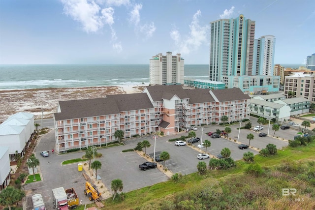 drone / aerial view with a water view and a beach view