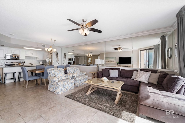 living room with crown molding, sink, and ceiling fan with notable chandelier