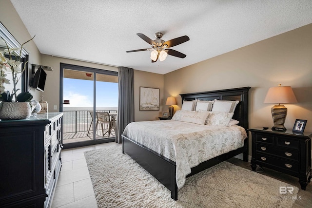 bedroom with light tile patterned floors, a textured ceiling, access to outside, and ceiling fan