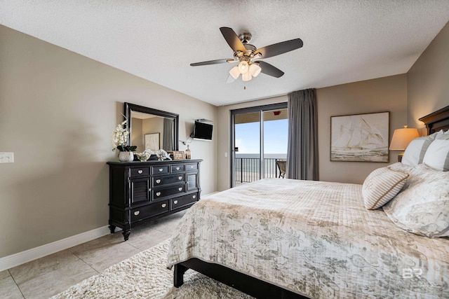 tiled bedroom with ceiling fan, a textured ceiling, and access to outside