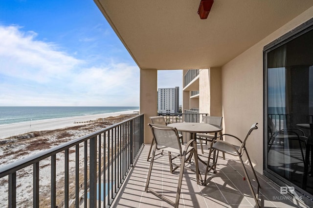 balcony featuring a water view and a view of the beach