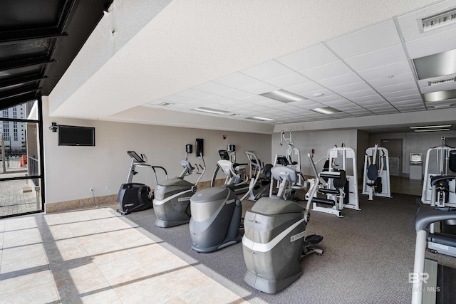 exercise room featuring a drop ceiling