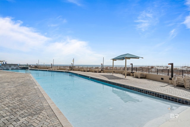 view of swimming pool featuring a water view