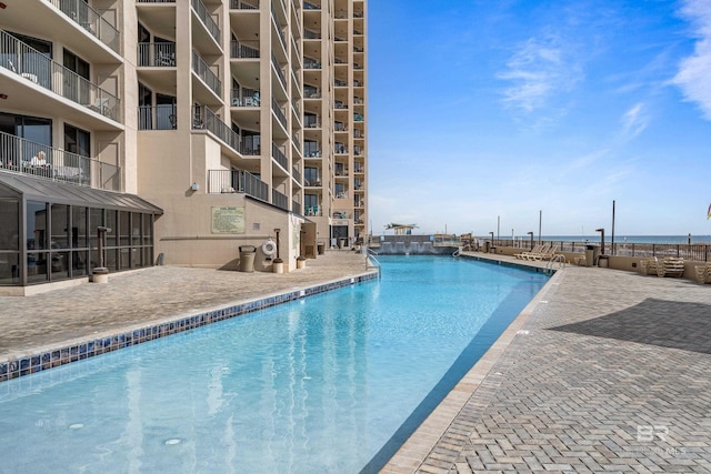 view of pool featuring a water view