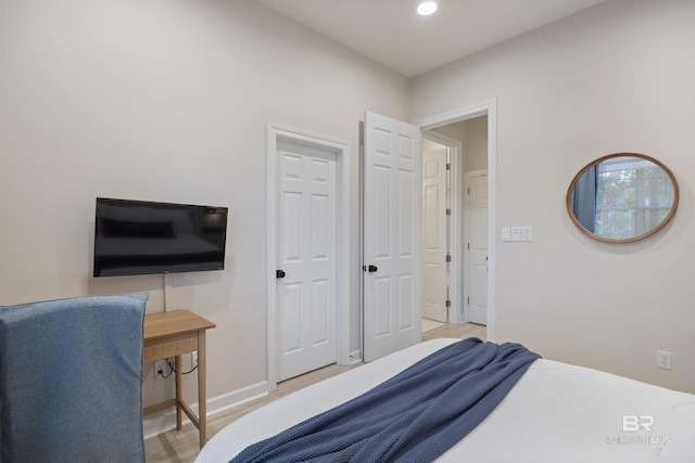 bedroom featuring light wood-type flooring, baseboards, and recessed lighting