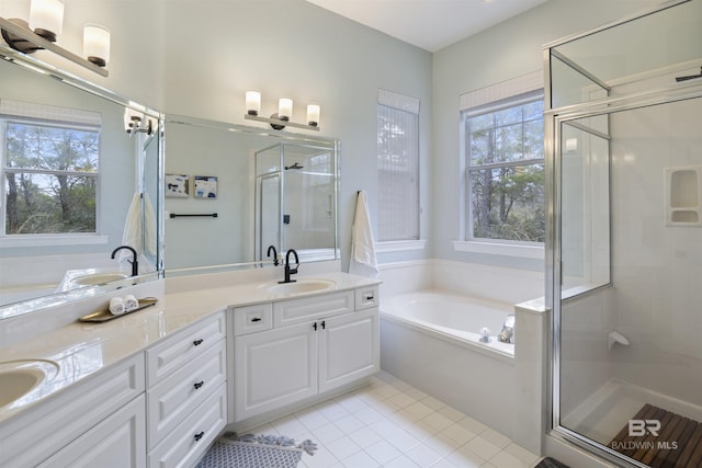 full bathroom with double vanity, a garden tub, and a shower stall