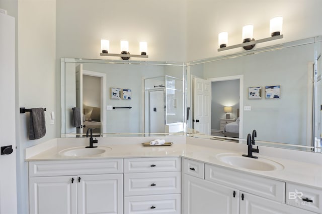 ensuite bathroom with a sink, a shower stall, ensuite bath, and double vanity