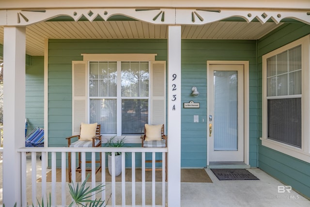 view of exterior entry featuring a porch