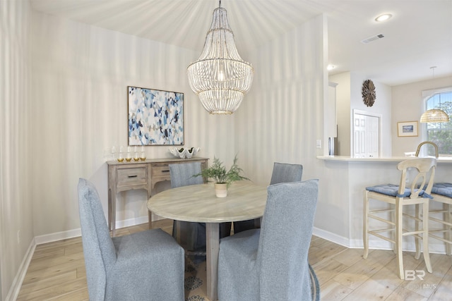 dining room with baseboards, visible vents, wood finished floors, a notable chandelier, and recessed lighting