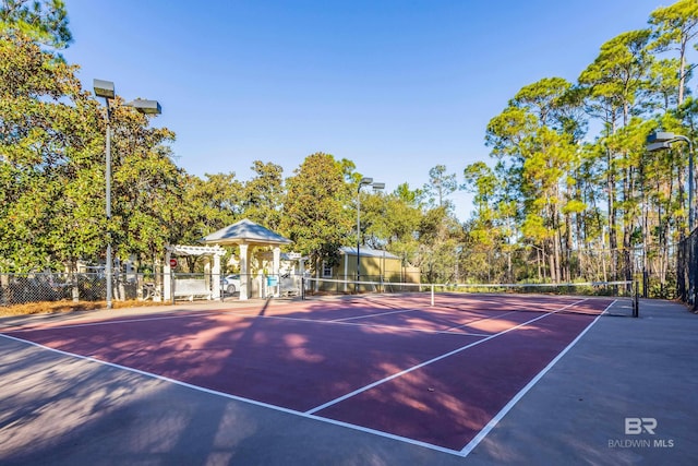 view of sport court featuring fence