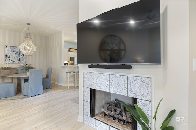 details featuring a fireplace, baseboards, and wood finished floors