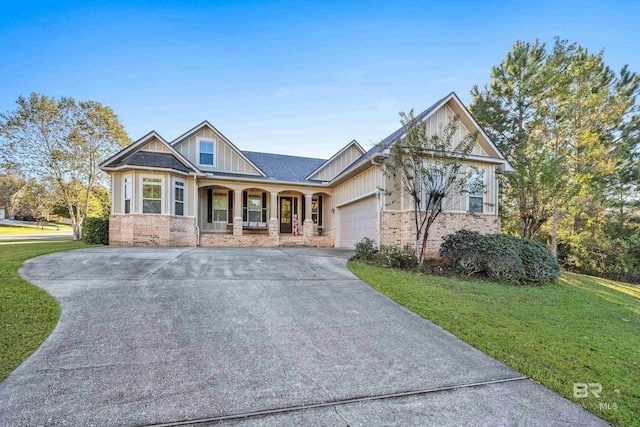 craftsman-style house with a garage, covered porch, and a front lawn