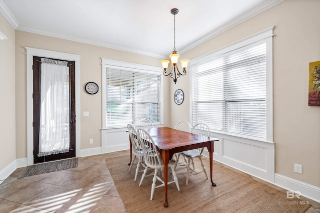 tiled dining space featuring a notable chandelier and crown molding