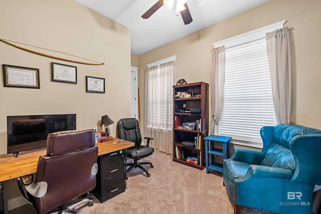 office area featuring ceiling fan and light carpet