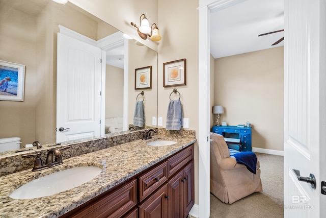 bathroom featuring vanity, ceiling fan, and toilet