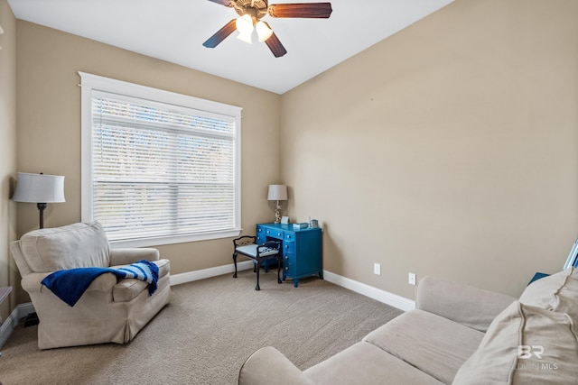 carpeted office space featuring ceiling fan