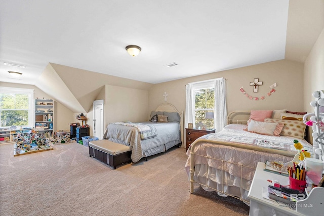 bedroom with carpet floors, multiple windows, and lofted ceiling