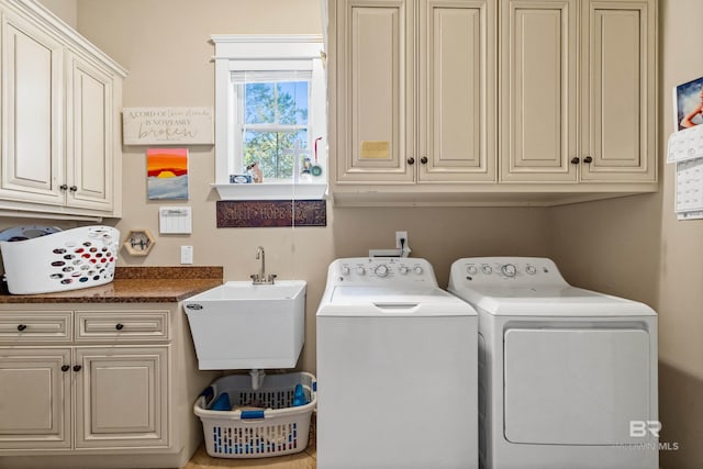 washroom featuring cabinets, separate washer and dryer, and sink