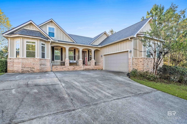 craftsman-style house featuring covered porch and a garage