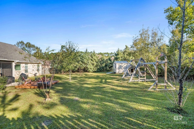 view of yard with a playground and a storage shed