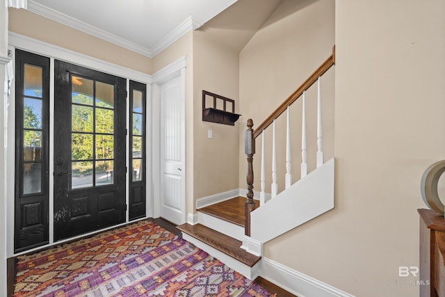 foyer entrance with wood-type flooring and crown molding