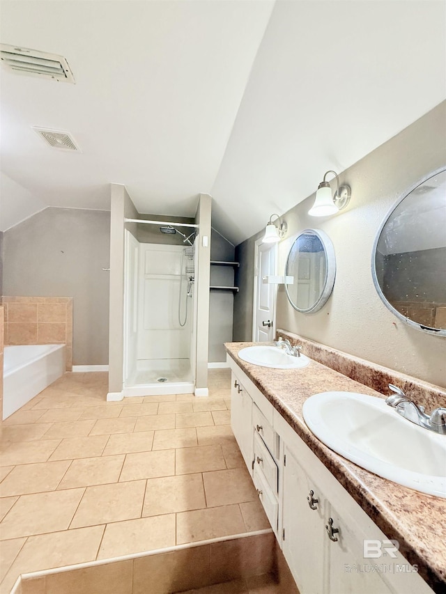 2371 Carriage Dr, Mobile, AL 36693 - bathroom with lofted ceiling, a stall shower, double vanity, a bath, and tile patterned floors