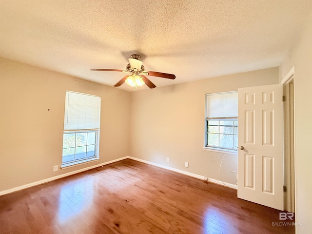 2371 Carriage Dr, Mobile, AL 36693 - empty room featuring healthy amount of natural light, wood finished floors, ceiling fan, and a textured ceiling