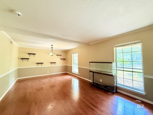 2371 Carriage Dr, Mobile, AL 36693 - unfurnished living room with crown molding, a textured ceiling, and wood finished floors