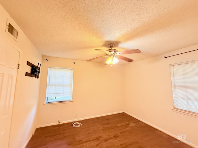 2371 Carriage Dr, Mobile, AL 36693 - empty room with wood finished floors, a textured ceiling, and a ceiling fan