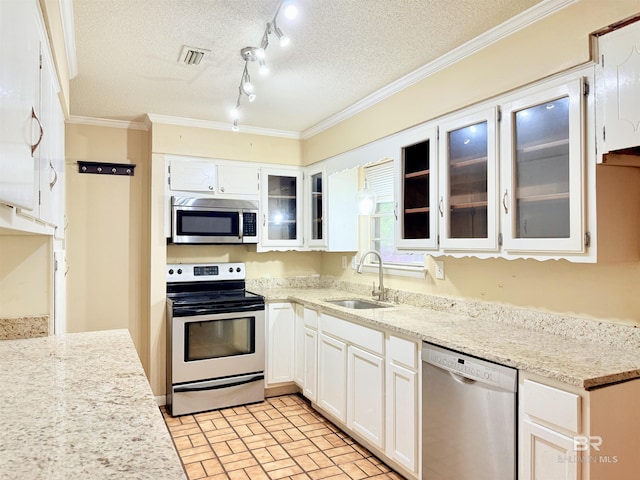 2371 Carriage Dr, Mobile, AL 36693 - kitchen featuring stainless steel appliances, a textured ceiling, crown molding, white cabinets, and glass insert cabinets