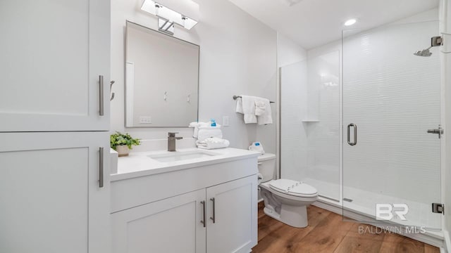 167 E J Cir, Gulf Shores, AL 36542 - full bathroom featuring toilet, a stall shower, wood finished floors, vanity, and recessed lighting