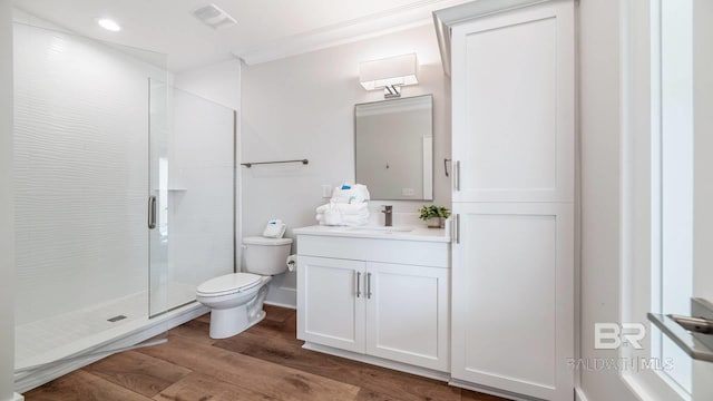 167 E J Cir, Gulf Shores, AL 36542 - bathroom featuring toilet, crown molding, wood finished floors, a shower stall, and vanity