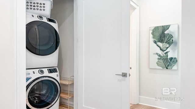 167 E J Cir, Gulf Shores, AL 36542 - clothes washing area featuring estacked washer and dryer and baseboards