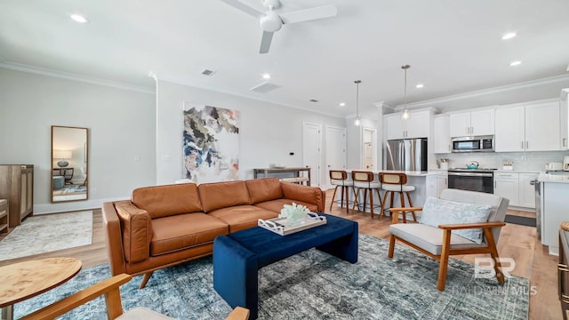 167 E J Cir, Gulf Shores, AL 36542 - living area featuring crown molding, light wood-type flooring, a ceiling fan, and recessed lighting