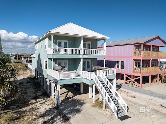 rear view of property with a balcony and a carport