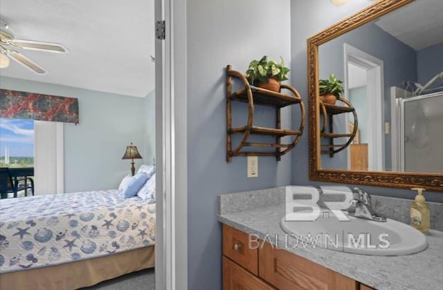 bathroom with vanity, a shower with door, and ceiling fan