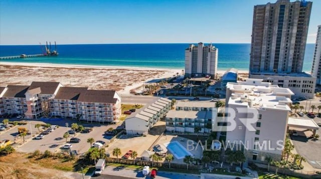 drone / aerial view featuring a water view and a beach view