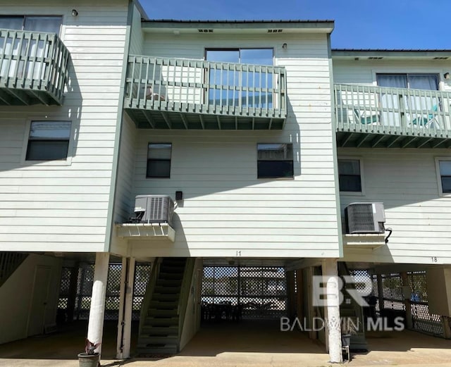 back of property featuring a carport and central AC unit