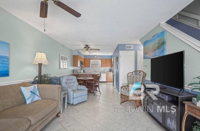 living room featuring ceiling fan and light tile patterned flooring