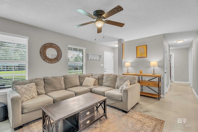 23214 Rochelle Loop, Robertsdale, AL 36567 - living area with a ceiling fan, concrete floors, and a textured ceiling