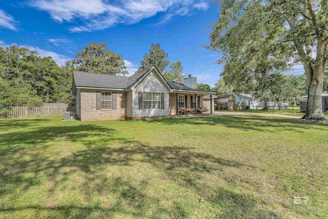 23214 Rochelle Loop, Robertsdale, AL 36567 - back of house featuring a chimney, brick siding, and a porch
