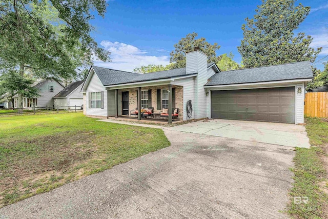 23214 Rochelle Loop, Robertsdale, AL 36567 - view of front of house featuring a porch, a garage, driveway, roof with shingles, and a chimney